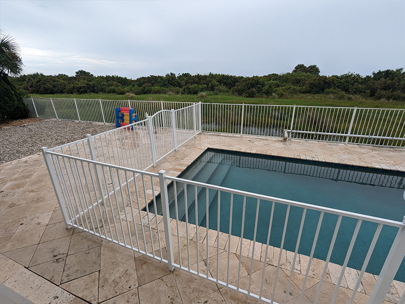 White aluminum pool fence installation in St. Augustine Florida