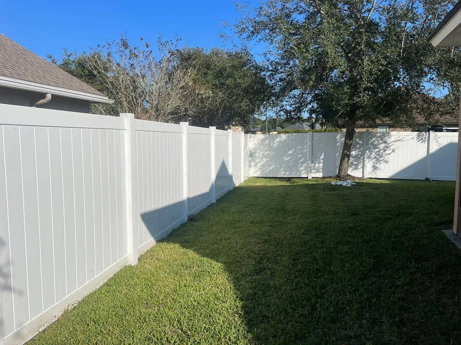Vinyl fence in beautiful landscaped yard